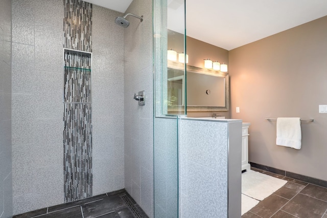 bathroom with baseboards, vanity, and walk in shower