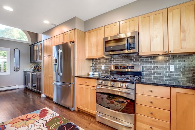 kitchen featuring light brown cabinets, appliances with stainless steel finishes, tasteful backsplash, and dark wood-type flooring