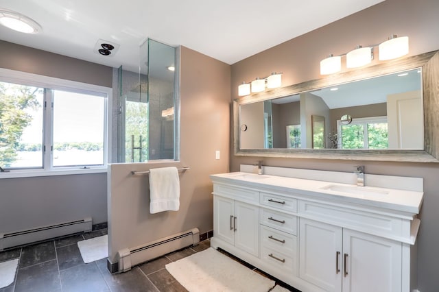 bathroom with double vanity, a sink, and a baseboard radiator