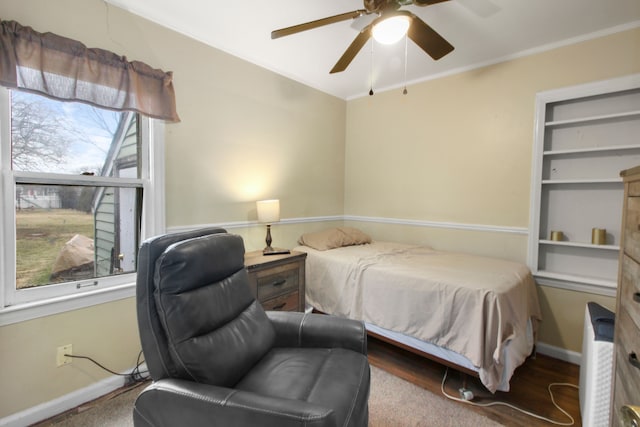 bedroom with ceiling fan, ornamental molding, and baseboards