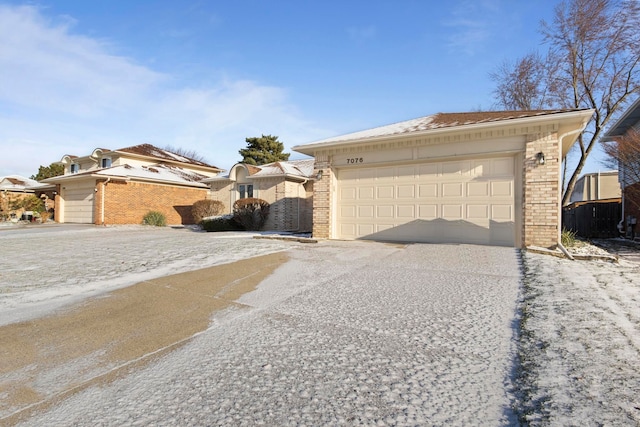 ranch-style house with a garage and brick siding