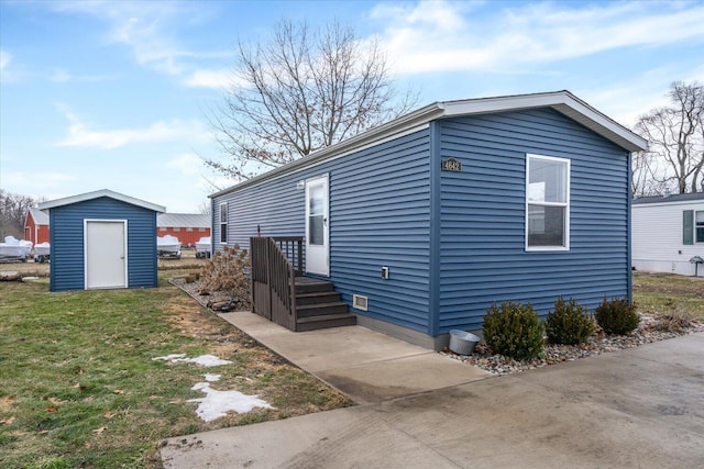 exterior space with a front yard, an outdoor structure, and a shed