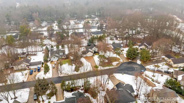 snowy aerial view with a residential view