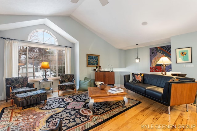 living area featuring lofted ceiling, a wealth of natural light, ceiling fan, and wood finished floors