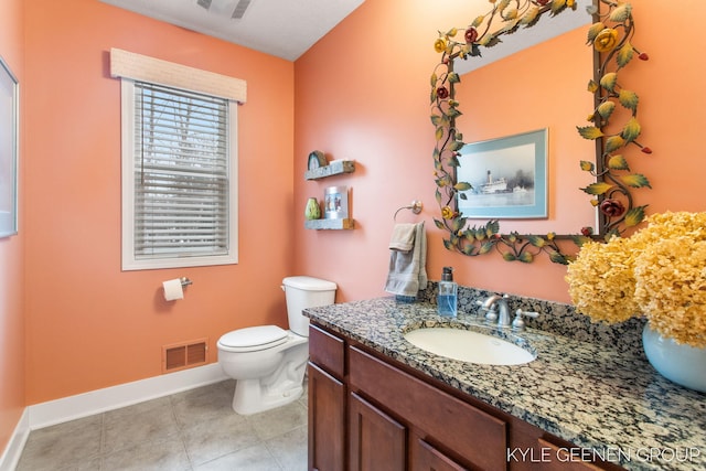 bathroom featuring tile patterned flooring, toilet, vanity, visible vents, and baseboards