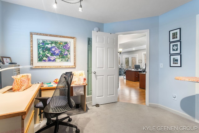 carpeted home office with baseboards