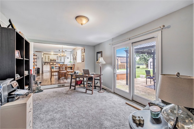 dining area with carpet flooring, baseboards, and an inviting chandelier