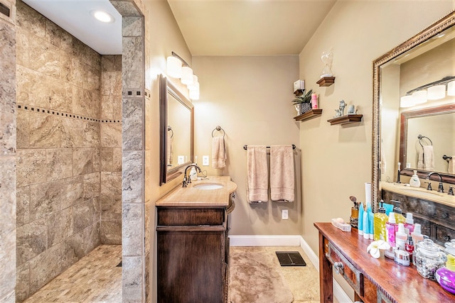 bathroom with vanity, baseboards, and a walk in shower