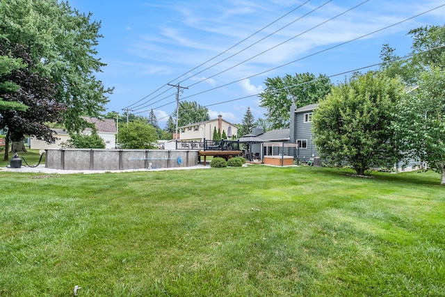 view of yard featuring a wooden deck and an outdoor pool