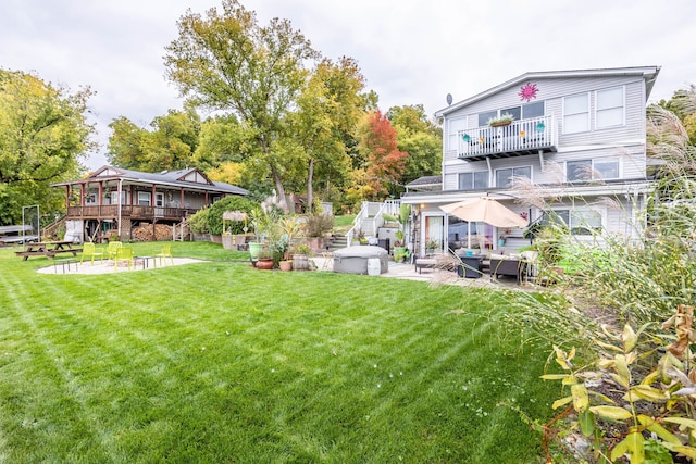 view of yard with stairs, a patio area, and a wooden deck