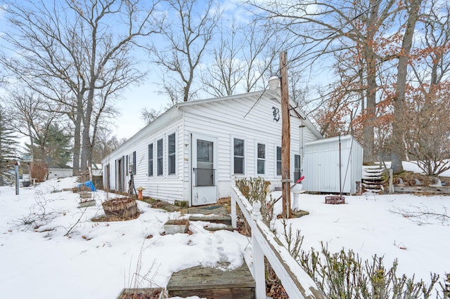 view of front facade with an outbuilding and a shed