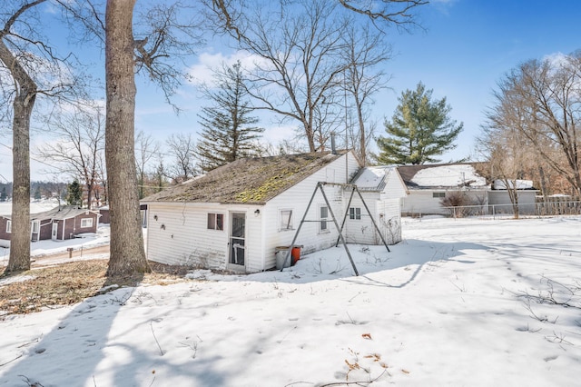 snow covered property featuring fence