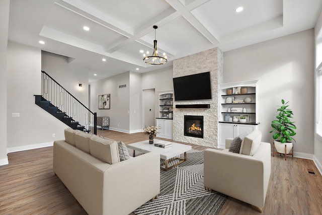 living room with stairs, baseboards, coffered ceiling, and wood finished floors