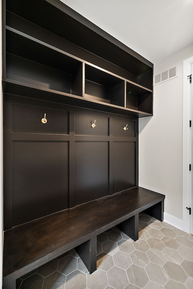 mudroom with tile patterned flooring, visible vents, and baseboards