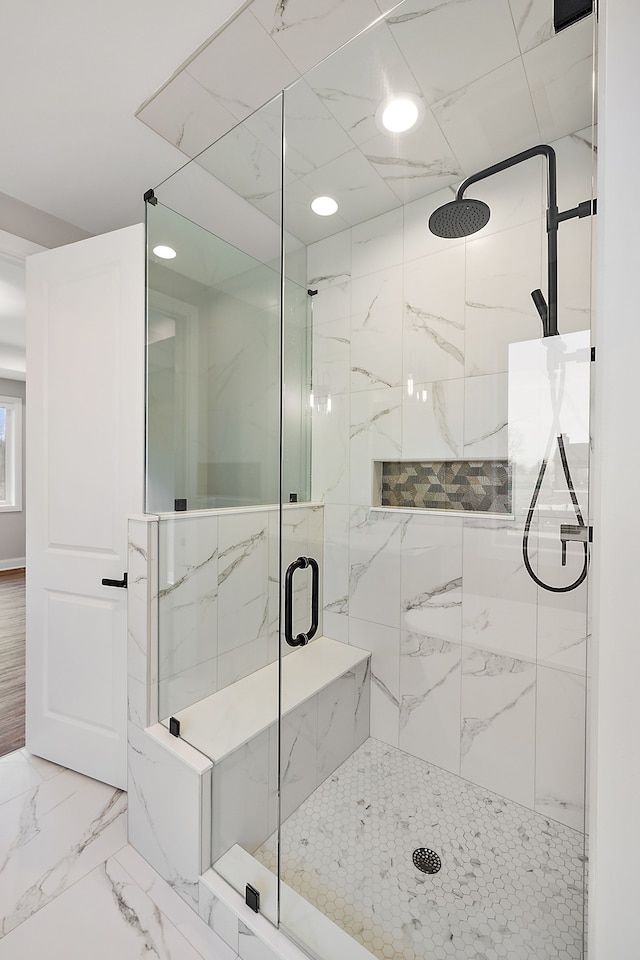 bathroom with marble finish floor, a marble finish shower, and recessed lighting