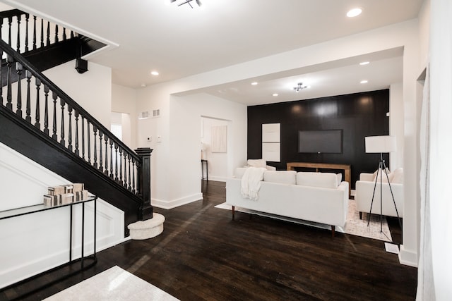 living room featuring stairs, recessed lighting, visible vents, and wood finished floors