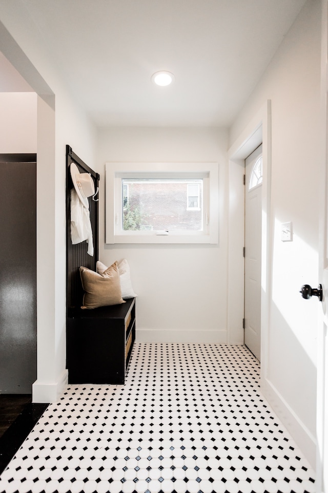 mudroom with light floors, recessed lighting, and baseboards