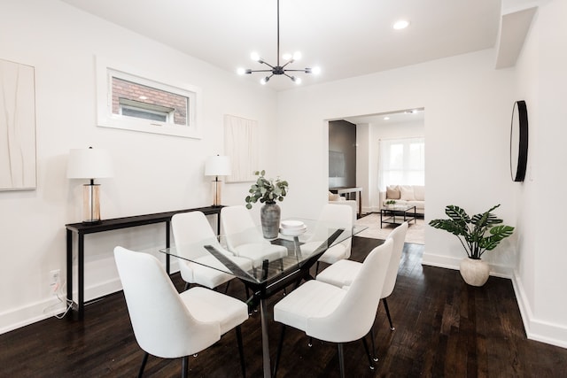 dining space with recessed lighting, a notable chandelier, baseboards, and wood finished floors