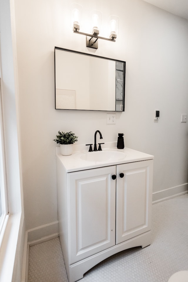 bathroom with vanity and baseboards