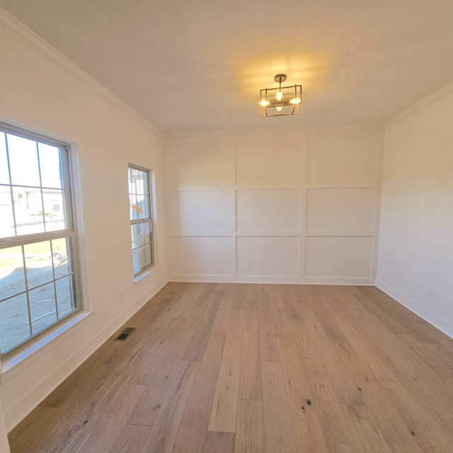 55786 Stewart Dr, Macomb, MI 48042 - unfurnished dining area featuring crown molding, light wood-style flooring, and baseboards