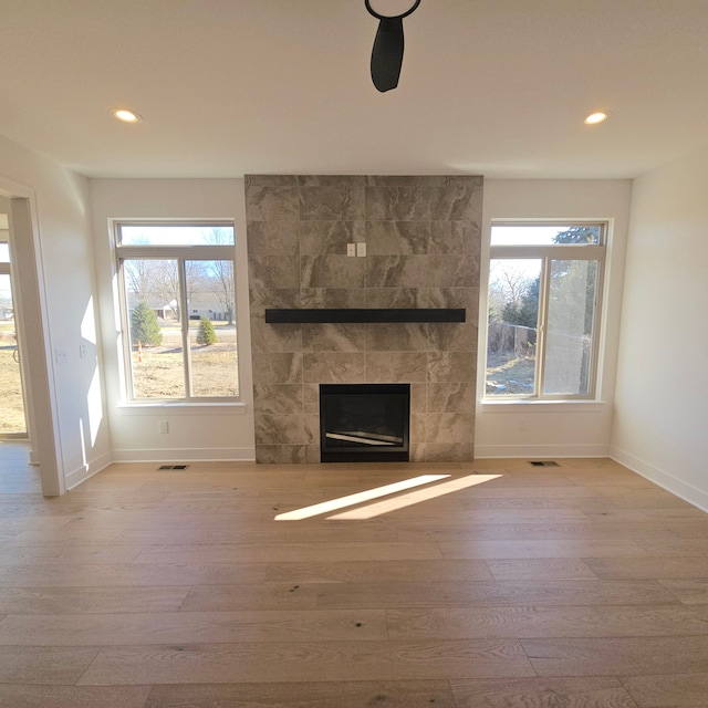 55786 Stewart Dr, Macomb, MI 48042 - unfurnished living room with wood finished floors, baseboards, recessed lighting, and healthy amount of natural light