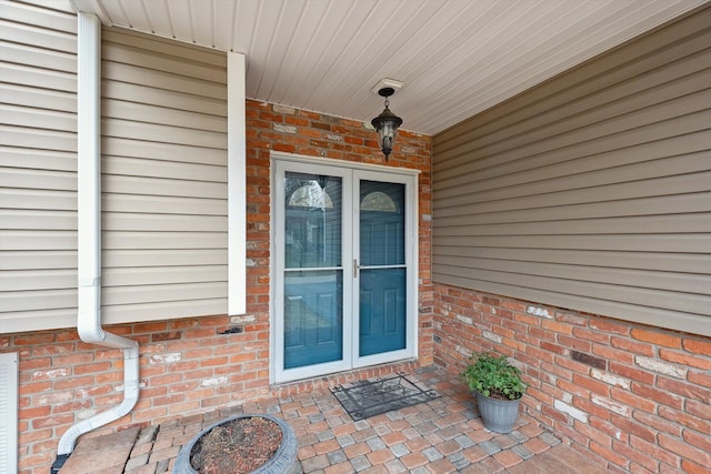 property entrance with brick siding