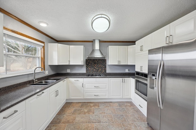 kitchen featuring a sink, stainless steel appliances, wall chimney exhaust hood, and white cabinets