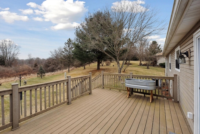 wooden deck featuring a yard