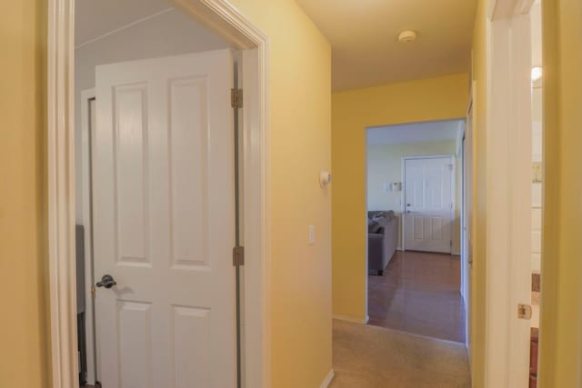 corridor with carpet and baseboards