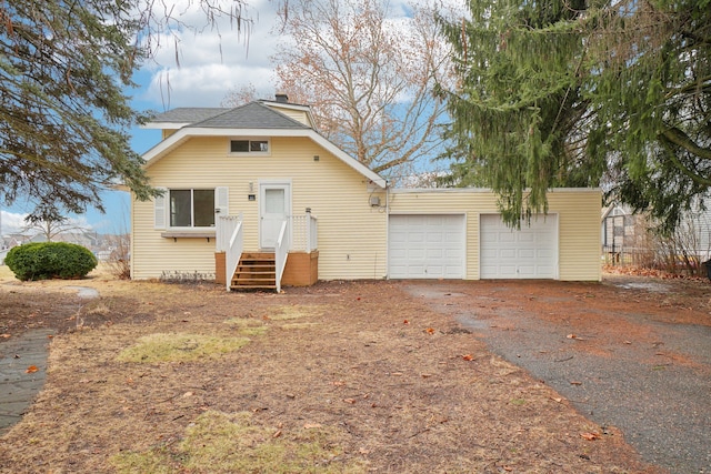 view of front of home with a garage and a chimney