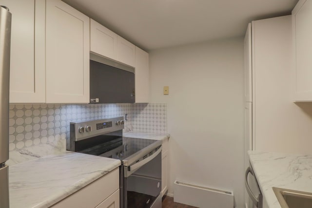 kitchen featuring white cabinets, light stone counters, backsplash, and stainless steel appliances