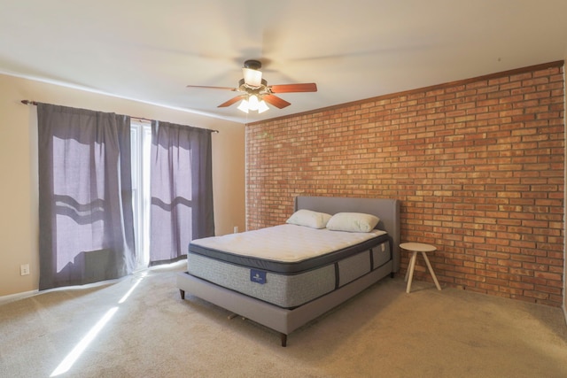 carpeted bedroom featuring brick wall and a ceiling fan