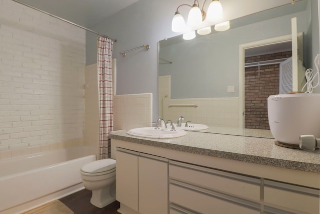 full bath featuring wood finished floors, toilet, shower / bath combo, and vanity