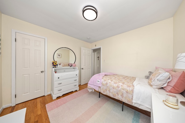 bedroom featuring light wood-type flooring and baseboards