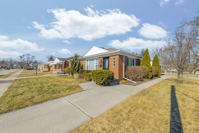 view of front of home featuring a front lawn and brick siding