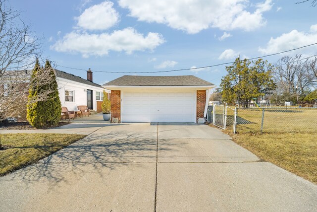 view of front of house featuring a garage, brick siding, a front lawn, and fence