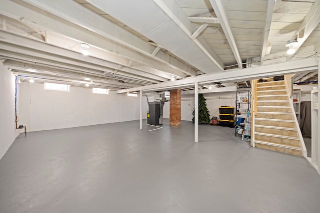 basement with stairway and heating unit