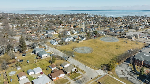 drone / aerial view with a water view and a residential view