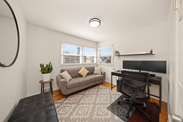 home office featuring baseboards and wood finished floors