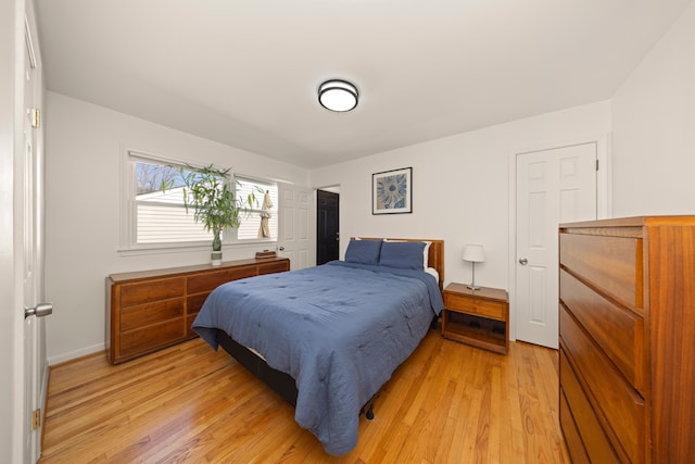 bedroom featuring light wood-type flooring and baseboards