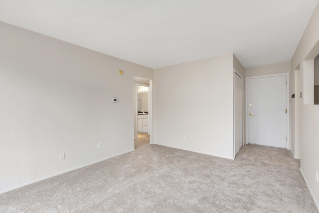 unfurnished room with light colored carpet