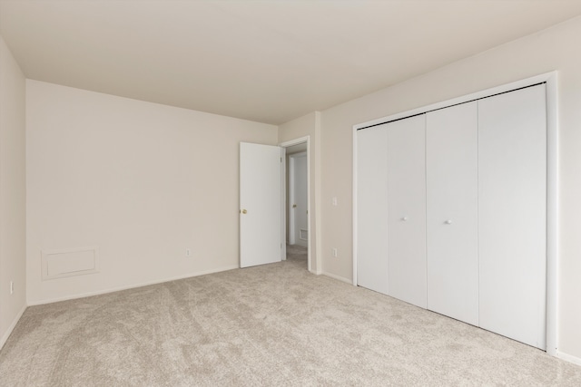 unfurnished bedroom with carpet floors and a closet