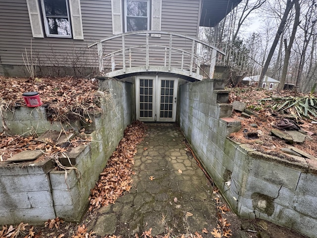 view of side of property with french doors and stairway