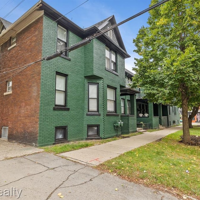 view of side of property featuring brick siding