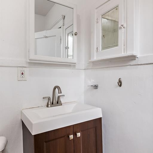 bathroom featuring vanity and toilet