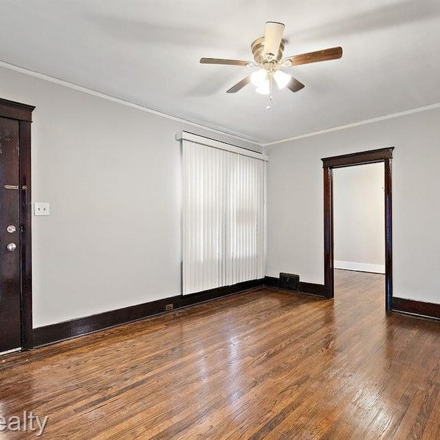 unfurnished room with baseboards, ceiling fan, wood finished floors, and crown molding