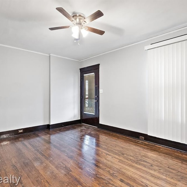 spare room featuring a ceiling fan, baseboards, ornamental molding, and wood finished floors