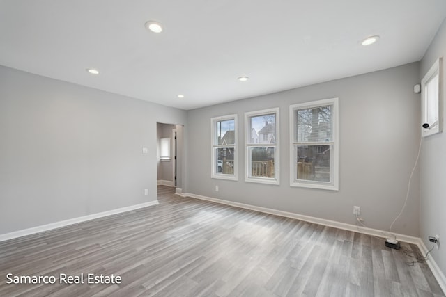 unfurnished room featuring recessed lighting, baseboards, and wood finished floors