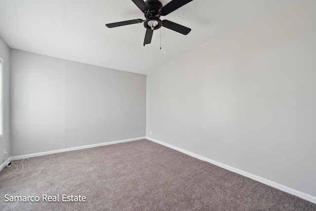 carpeted empty room with ceiling fan, baseboards, and vaulted ceiling