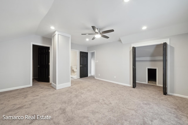 unfurnished bedroom featuring ensuite bathroom, a spacious closet, recessed lighting, and baseboards